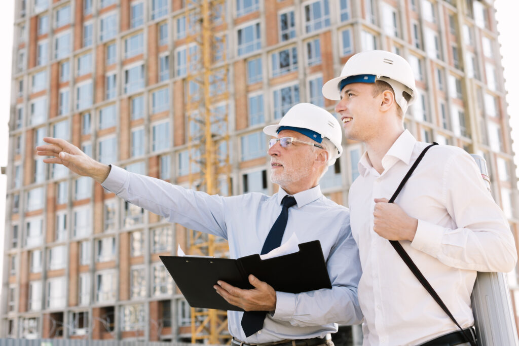 low angle old man with helmet pointing something